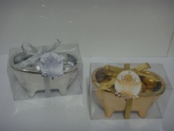 bath bombs wrapped with silver paper in bathtub